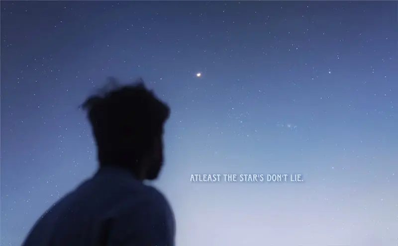 A silhouette looking toward a star-filled sky