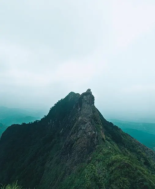A rugged mountain peak beneath low clouds