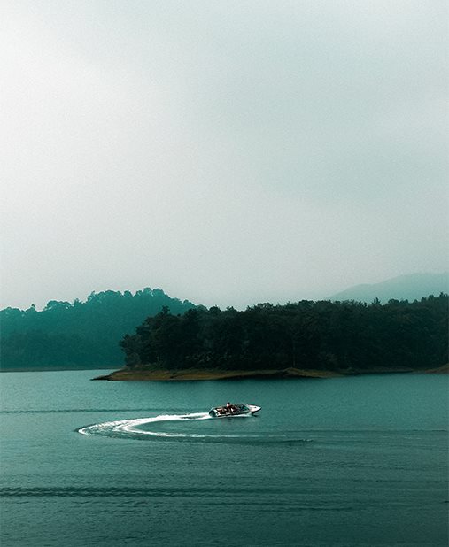 A watercraft leaving a curved wake on blue water
