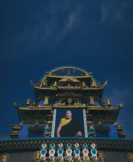 An ornate temple entrance against a dark blue sky