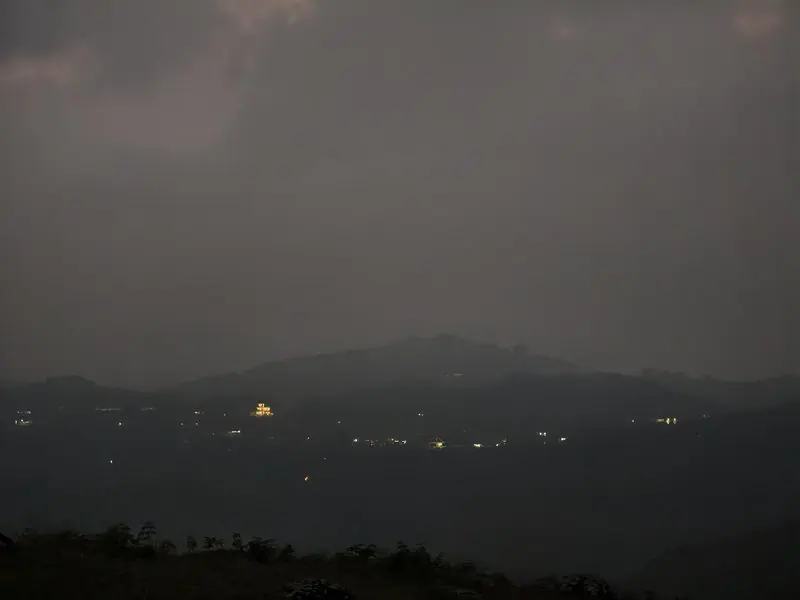 Small lights across distant hills after sunset