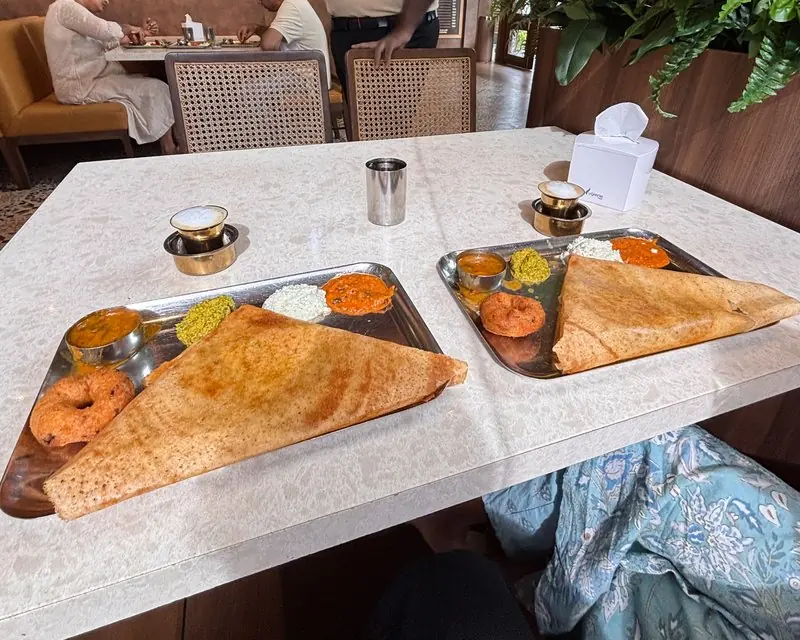 Two breakfast plates and cups on a cafe table